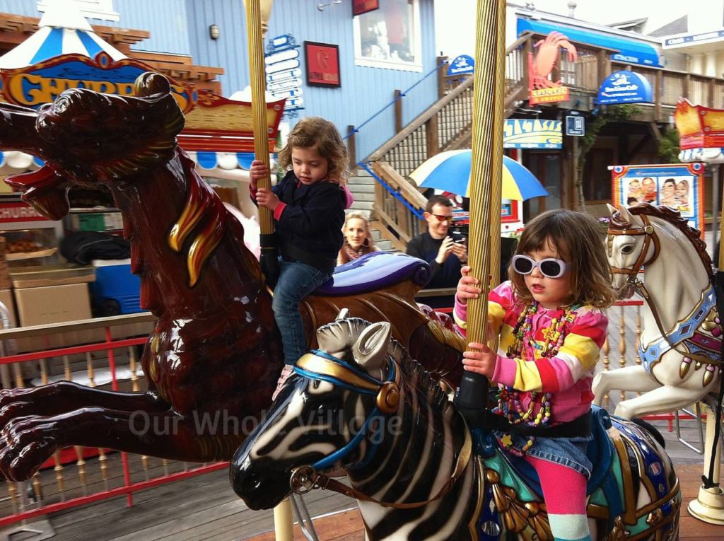 The double-decker carousel at Pier 39. Stripes-on-stripes, layered necklaces and funky shades, optional.